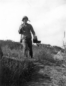 Martin J. Bolhower carrying camera in the field