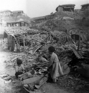 Korean children in the ruins of a village