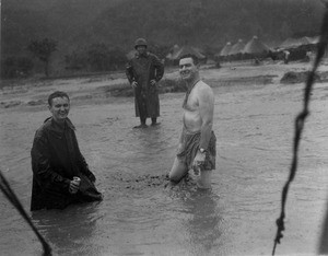 Soldiers wading in a stream