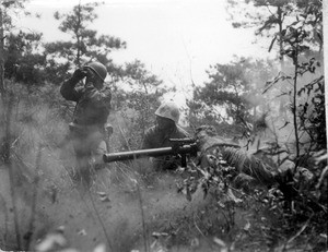 Marine gun crew firing a gun at Chinese