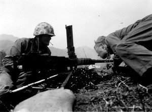 Marines lighting cigarettes from hot gun barrels