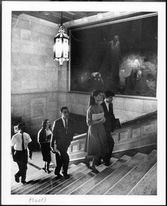 Students ascend the stairs in Doheny Memorial Library, ca.1950s