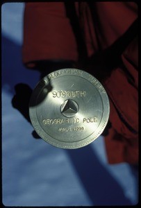 Close-up of the geographic South Pole marker, 1996