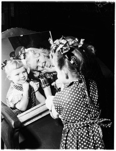 Christmas ...Los Angeles Orphanage kids get new hair ribbons, 1951