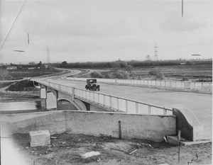 A car is crossing the Washington Street Bridge over the Rio Hondo in Pico Rivera, CA