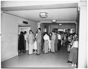 Crowds of couples waiting in line at Marriage License Bureau, 1953