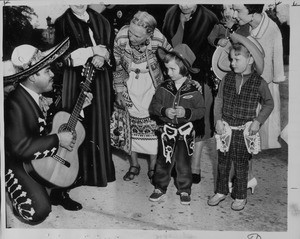 Don Juan Benavides singing to children in City Hall plaza, Pasadena, 1961