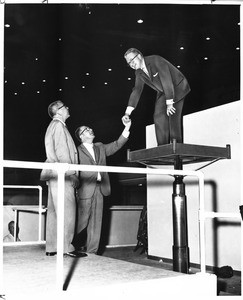 J. Leonard Reinsch is lauded on Los Angeles Memorial Sports Arena elevator test by Jack Christie, 1960