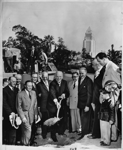 First shovelful of dirt is wielded by Chief Justice Earl Warren during ground-breaking ceremonies for $17,000,000 county courthouse here in Los Angeles, 1954