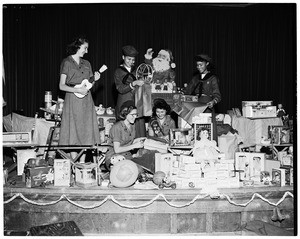 Christmas gifts wrapped for orphans' party, 1952