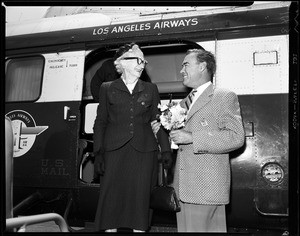 1 image. Coptering in for mother's day, 08 May 1955. Mrs. Phoebe Browne-80 years; Laverne W. Browne (test pilot for El Segundo division of Douglas Aircraft company); (handout)