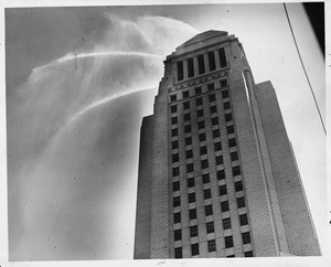 Water shoots out from nozzles set atop Los Angeles City Hall in a demonstration by Fire Department, 1928