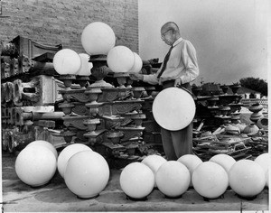 J.A. Lindhardt, examines the ornate street light fixtures, Los Angeles, 1959