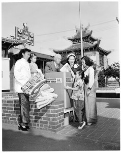 Chinese American women donate blankets to Korean children, 1953