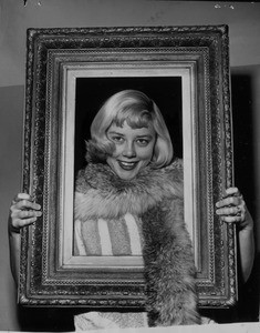 Mrs. Katie Hansen shows fur neckpiece and antique frame, Pasadena, 1953