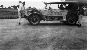 Chrysler with sign "Tsingtao to Chefoo, Roads or no Roads"