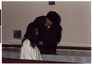 Mihael Kuzmič baptizing a young woman