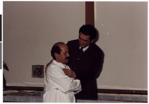 Mihael Kuzmič baptizing an older man