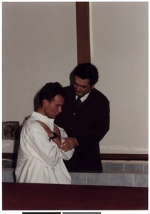 Mihael Kuzmič baptizing a young man