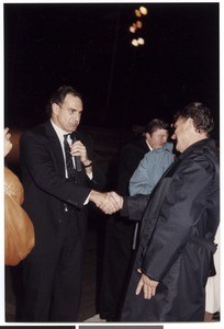 Evangelist shaking hands with a man