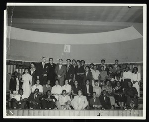 Large group students posing for a photograph on stage, 1920's