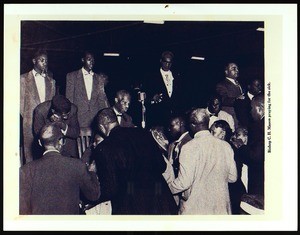 Bishop C.H. Mason praying for the sick