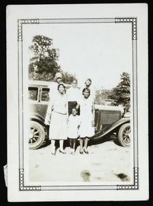 Unidentified family in front of automobile, 1920s-1940s