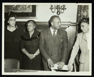 Four unidentified poeple at the chapel assembly of OMAT trainees, 1965