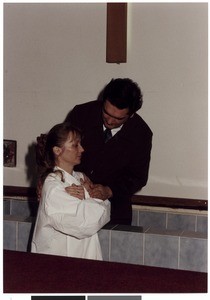 Mihael Kuzmič baptizing a woman