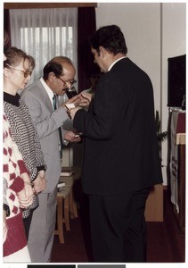 Baptized older man participating in Lord's Supper