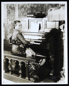 Mother Coffee sitting at an organ