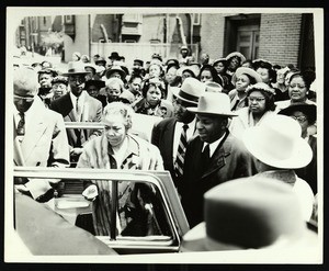 Unidentified woman getting in car, COGIC national convention