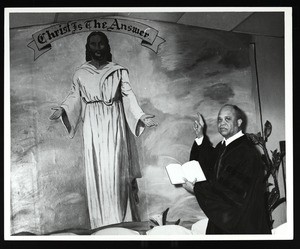 COGIC pastor near a painting of Jesus Christ, Chicago