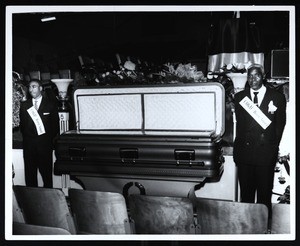 COGIC honor guard beside open casket