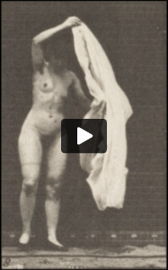 Nude woman inside toilet, stooping and throwing a wrap around shoulders