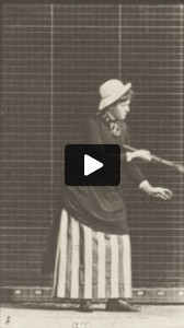 Woman in long dress playing lawn tennis