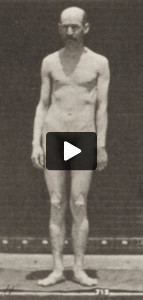 Nude man standing and moving arms