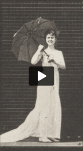 Draped woman opening a parasol and turning around