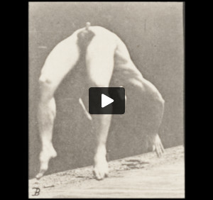 Nude man doing a handspring