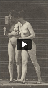 Two nude women walking arm in arm and turning around; one flirting a fan