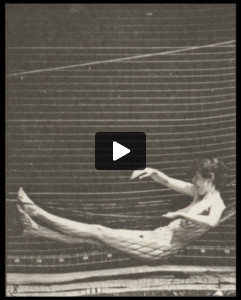 Nude woman getting into a hammock