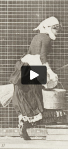 Woman turning to ascend stairs with a bucket of water and broom in hands