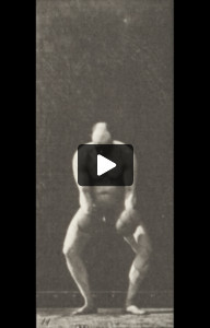 Nude man lifting and holding two 50-lb dumbbells