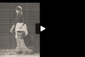 Draped woman emptying a bucket of water