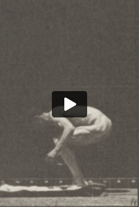 Nude man performing back somersault