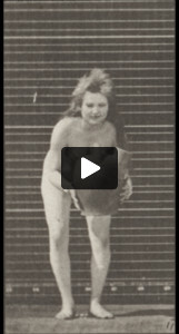 Nude woman turning and lifting a water jar from the ground