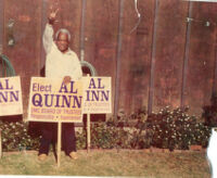 Alfred Thomas Quinn posing with an Elect Al Quinn sign