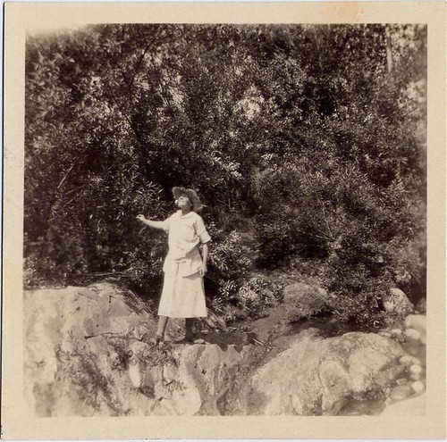 Woman Standing on Edge of Rocks