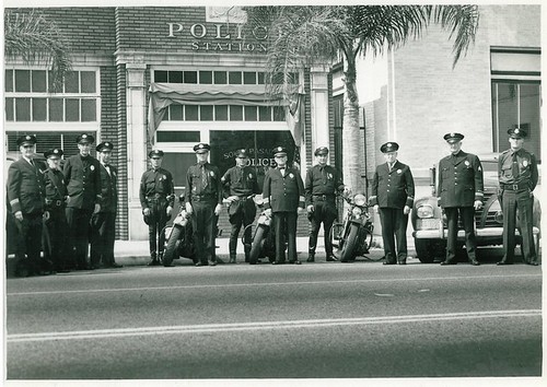 Police Officers Posing with Their Motorcycles in Front of Police Station