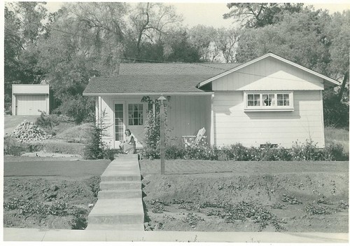 Woman Sitting on Front Steps of House